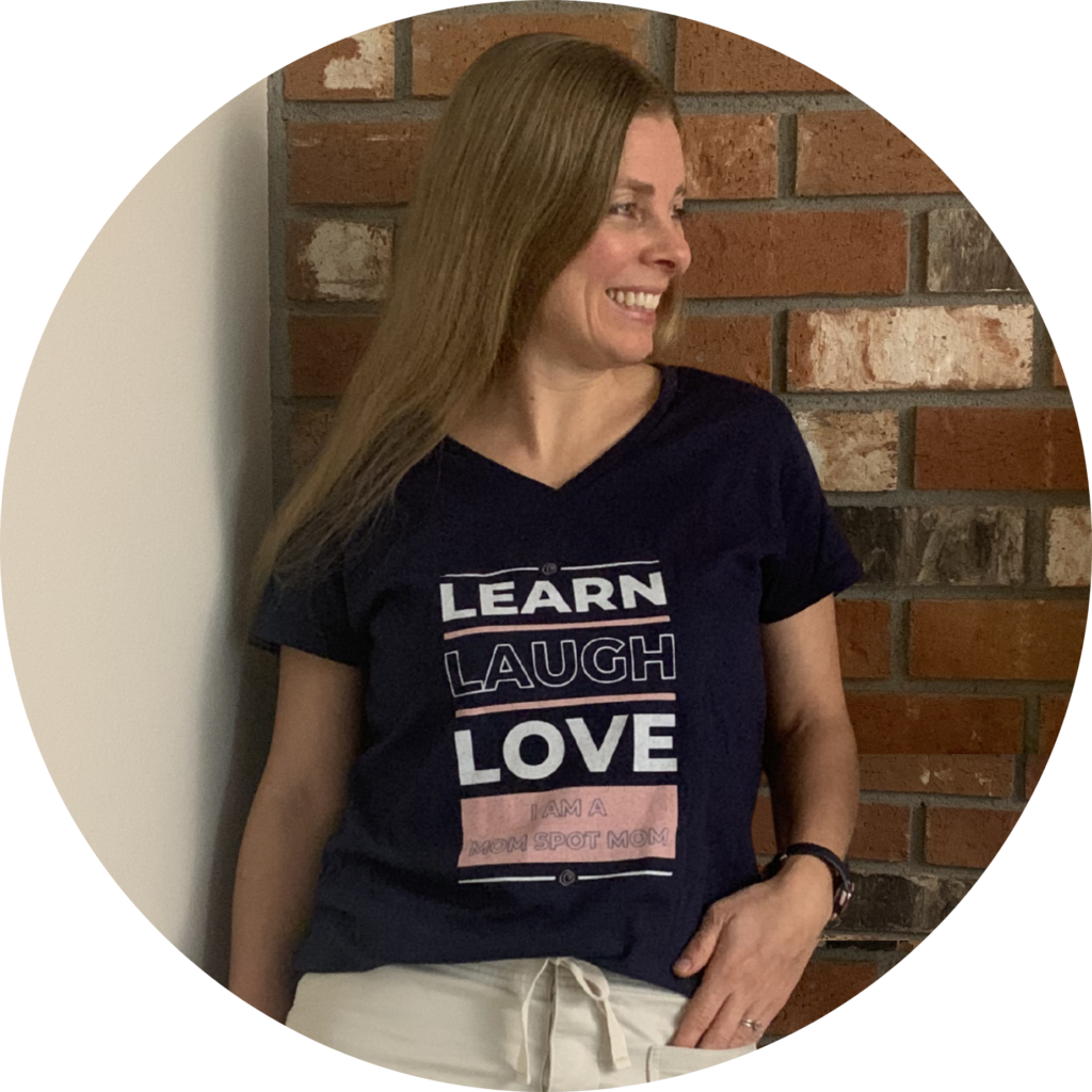 This is an image of Marielle Melling wearing a Mom Spot t-shirt that says, "Learn, Laugh, Love. I am a Mom Spot Mom."